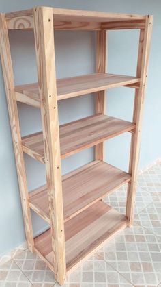 a wooden shelf sitting on top of a tiled floor