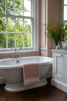 a white bath tub sitting next to a window