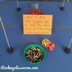 a sign that says roll 2 dice and count on to find the total next out that many beads on the drawer