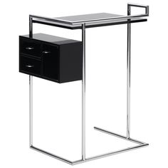 a black and chrome side table with two drawers on one end, an open drawer on the other