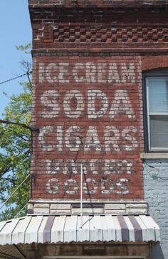 an old sign on the side of a building