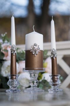 three candles are sitting next to each other on a table