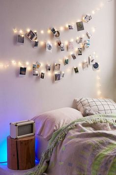 a bedroom with lights and pictures on the wall