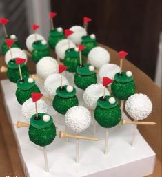 some green and white cake pops with red flags on them