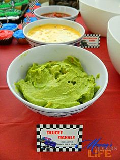 bowls of guacamole and cupcakes on a red table cloth at a race themed birthday party