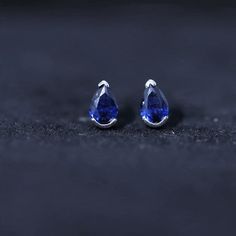 Product Details Elevate your style and stay on-trend with our stunning Solitaire Teardrop Earrings. Each earring features a Pear Cut Created Blue Sapphire, exquisitely set in a half Bezel Setting. These understated yet beautiful stud earrings are the perfect accessory to showcase your elegance. With a range of metal options available, you can customize these earrings to perfectly complement your unique style. Make a fashion statement and adorn yourself with these timeless gems. Product Informati Sapphire Pear-shaped Earrings For Wedding, Luxury Sapphire Teardrop Earrings, Fine Jewelry Sapphire Pear-shaped Earrings, Sapphire Pear-shaped Earrings Fine Jewelry, Luxury Sapphire Pear-shaped Earrings, Half Bezel Setting, Beautiful Stud Earrings, Half Bezel, Sapphire Solitaire