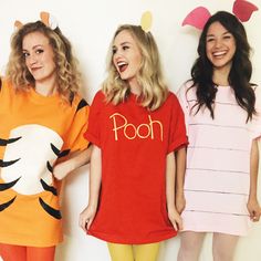 three women in winnie the pooh costumes standing next to each other with their mouths open