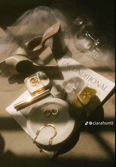 the contents of a purse and shoes are laid out on the floor