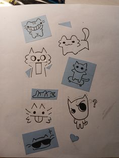 a piece of paper that has some drawings on it with cats and dogs drawn on it