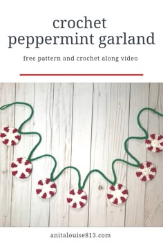 the crochet peppermint garland is made with red and white yarn on a wooden background