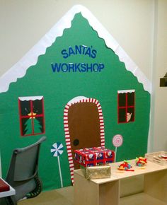 a child's playroom with toys and decorations on the walls, including a green house