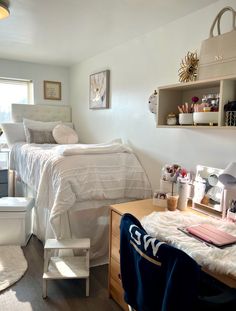 a bedroom with a bed, desk, chair and shelves on the wall above it