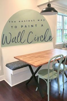 Green circle painted above a banquette bench behind a table. Painting Headboard Ideas On Wall, Boho Geometric Wall Paint, Circle Feature Wall Bedroom, Paint Half Circle On Wall, Half Moon Painted Wall, Painted Wall As Headboard, Painted Half Circle Headboard, Painted Oval Accent Wall, Painted Wall Feature