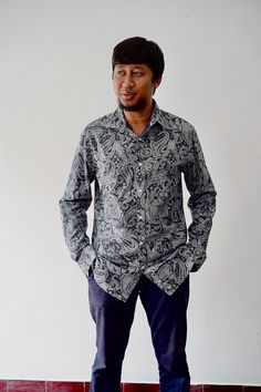 This classic long-sleeve shirt features an intricate paisley design that exudes a vintage charm perfect for the discerning gentleman. The shirt's deep blue and grey tones create a sophisticated and timeless look, making it an ideal piece for both casual and formal settings. The soft, breathable fabric ensures comfort, while the tailored fit adds a touch of elegance. The paisley pattern, popular in those before 90s period, adds a retro vibe that's both stylish and unique. Whether paired with form Classic Paisley Print Button-up Shirt, Classic Long Sleeve Shirt With Paisley Print, Classic Patterned Long Sleeve Shirt, Classic Long Sleeve Paisley Print Shirt, Classic Long Sleeve Patterned Shirt, Blue Paisley Print Long Sleeve Shirt, Long Sleeve Shirt With Paisley Print For Fall, Long Sleeve Cotton Shirt With Paisley Print, Fall Cotton Shirt With Paisley Print