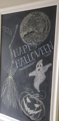 a chalkboard with the words happy halloween written on it