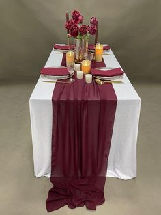 the table is set with candles and flowers