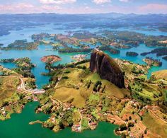 an aerial view of a lake surrounded by mountains