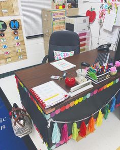 the desk is decorated with colorful tassels and decorations