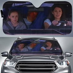 two women are driving in the back seat of a car with their reflection on the windshield