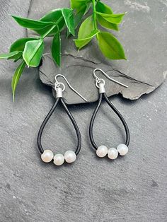 The genuine black leather with beautiful white freshwater pearls makes these Southwestern-style teardrop earrings a great addition to any collection. Lightweight with silver findings, they are the perfect accessory to add chicness to any outfit and complement almost everything. EARRING FEATURES Lightweight Total Length: 2.25 inches Material: Genuine Black Leather & Freshwater Pearls ♥ All orders come beautifully hand-packaged with care, making it the perfect gift for yourself or someone special. ♥ Each piece is handmade with love in my home studio in Rockaway, NJ. Adjustable Nickel-free Teardrop Pearl Earrings, Adjustable Teardrop Pearl Drop Earrings, Leather Teardrop Jewelry, Elegant Leather Earrings With Ear Wire, Elegant Leather Dangle Earrings, Elegant Teardrop Leather Jewelry, Elegant Leather Dangle Jewelry, Diy Pumpkins Crafts, Jewelry Black