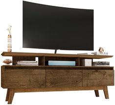 a large flat screen tv mounted on top of a wooden entertainment center