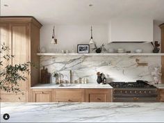 an image of a kitchen setting with marble counter tops and wooden cabinets, including a stove top