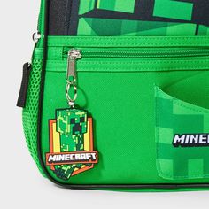 Bring a fun gaming-themed update to your kid's backpack collection with the Minecraft Creeper 12-Inch Backpack. Showcasing a creeper print, this green backpack makes a perfect gift for birthdays or any other occasion. It's designed with a large interior compartment plus exterior and side pockets to give them ample space for their notebooks, water bottle and other essentials. Made with woven fabric, this mini backpack is suggested for ages three and above, and it's easy to carry with the top hand Themed Green Standard Backpack, Green Standard Backpack, Green Novelty Rectangular Bag, Novelty Green Rectangular Bag, Green School Backpack With Zipper Closure, Green Novelty Bags For Back To School, Green Backpack With Zipper Closure For School, Green Standard Backpack For School Events, Green Backpack For School Events