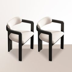 two black and white chairs sitting next to each other