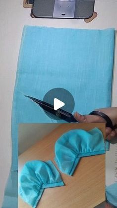 someone is using scissors to cut fabric on a table with a skateboard in the background