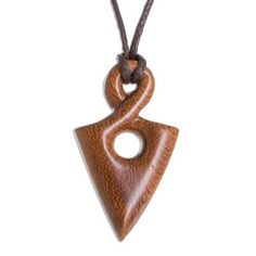 a wooden pendant on a cord