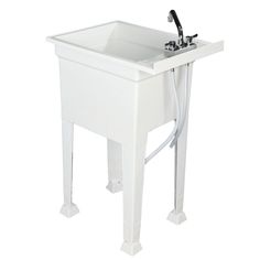 a white sink sitting under a faucet on top of a table