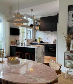 a kitchen with marble table and chairs in it