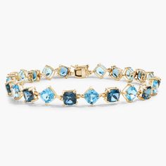 This elegant bracelet features brilliant cushion-cut London blue topaz and Swiss blue topaz stones spaced along its length in eye-catching alternating orientations. It is crafted in luxurious 14k yellow gold for a beautiful look that delivers lasting quality. Precious Gemstones Jewelry, Blue Topaz Stone, Elegant Bracelet, Swiss Blue Topaz, Topaz Stone, London Blue Topaz, London Blue, Cushion Cut, Blue Topaz