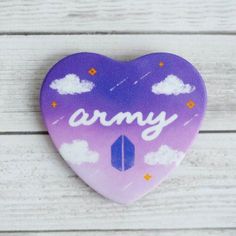 a purple heart shaped brooch with the word army painted on it's side