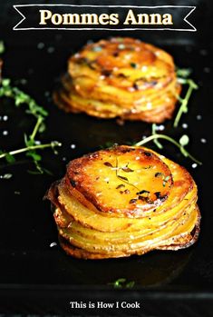 some food is on a black plate with the words pommes anna above it