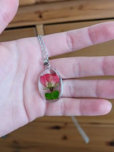 The charm for the necklace is made from epoxy resin with a real pressed flower inside. The flower is a rose bud from Idaho. It has a metal base around the charm, which matches the chain. It is very lightweight and perfect for any occasion, whether formal or casual. Rose Flower Jewelry With Pressed Flowers, Rose Flower Shaped Jewelry With Pressed Flowers, Kind Person, Green Goddess, Rose Bud, Wing Earrings, Pressed Flower, Real Flowers, A Rose