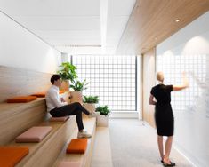 two people are sitting on the stairs in an office