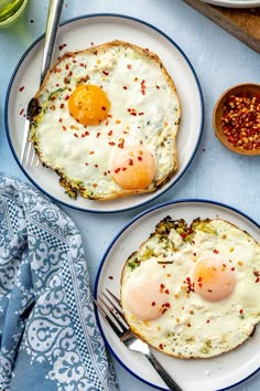 two plates with eggs and toast on them