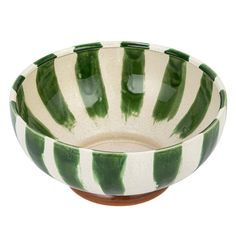 a green and white bowl sitting on top of a table