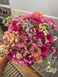 a person holding a bouquet of flowers in their hand