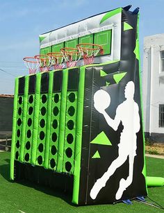 an inflatable basketball court is set up on the grass