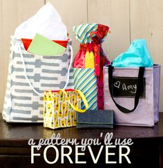 three bags sitting on top of a table with the words make a fabric gift bag