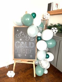 a chalkboard with balloons and snowflakes on it