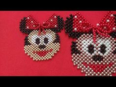 two beaded mickey and minnie mouse earrings on a red background with the words disney world