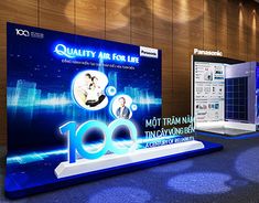 an exhibition booth with blue lighting and large signs on the wall that read quality air for life