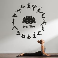 a woman doing yoga in front of a wall with the words yoga time