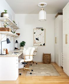 an office with white walls and wooden floors is pictured in this image, there are two chairs on the desk