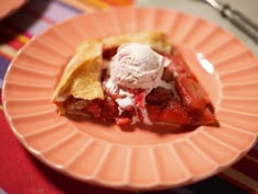 a piece of pie with ice cream on top is sitting on a pink paper plate