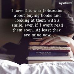 a woman laying in bed with books stacked on her head