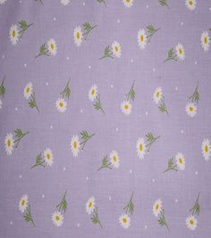 the fabric has daisies on it and is purple with white dots, green leaves and yellow centers